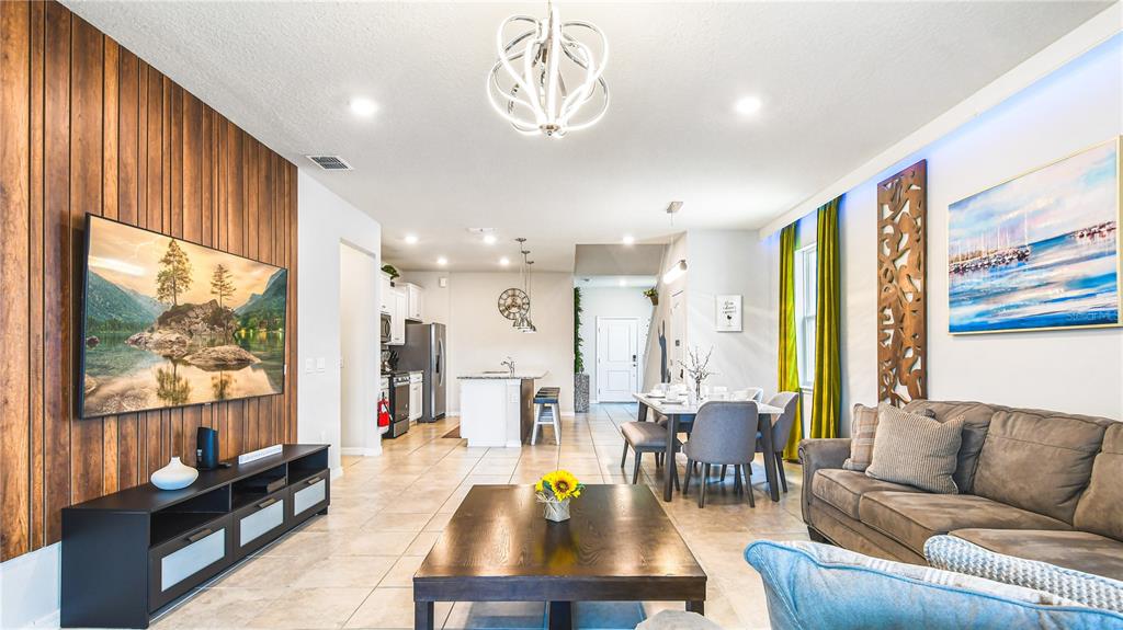 7219 Oakmoss Loop Davenport, FL 33837 - Photo 13 of 54 a living room with furniture and a large window