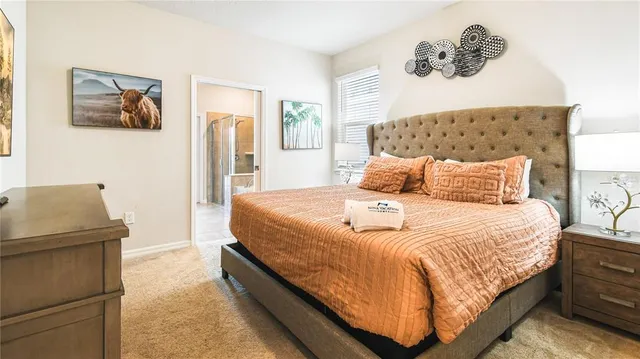 a bedroom with a bed and painting on the wall