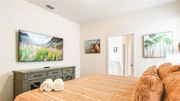 a bedroom with a bed and a flat screen tv