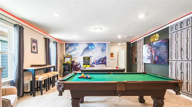 a very nice looking room with many windows and furniture