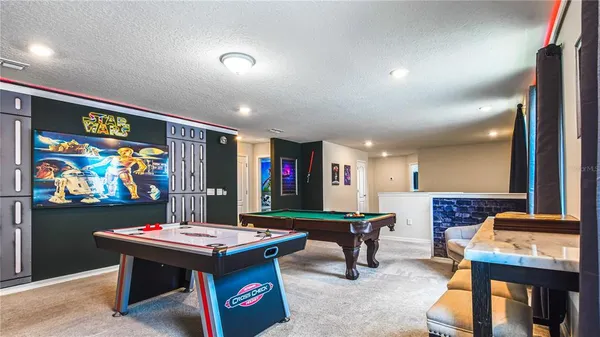 a outdoor kitchen with a table and chairs
