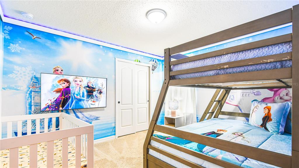 7219 Oakmoss Loop Davenport, FL 33837 - Photo 32 of 54 a bedroom with a bed and a painting on the wall