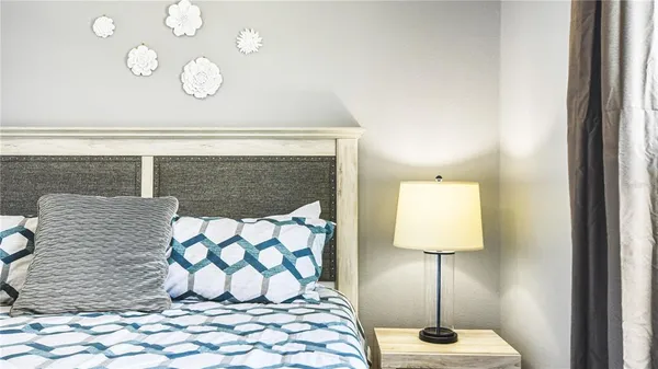 a large bed sitting in a bedroom next to a window