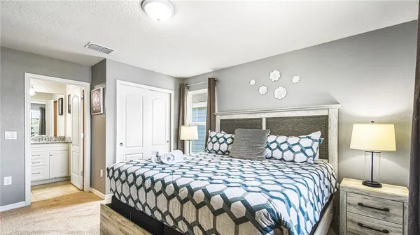 a bedroom with a bed and a dresser