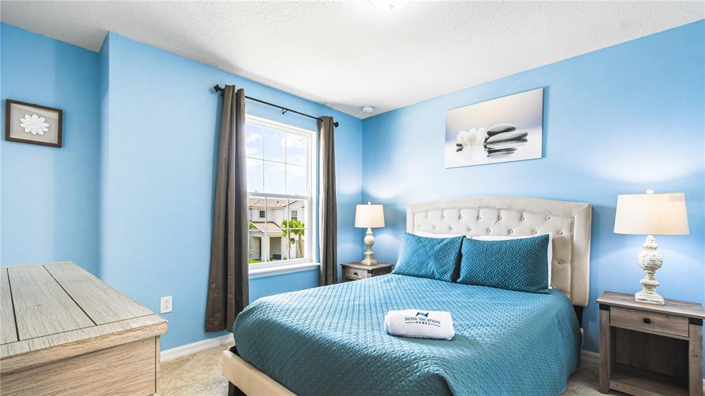 7219 Oakmoss Loop Davenport, FL 33837 - Photo 44 of 54 a large bed sitting in a bedroom next to a window