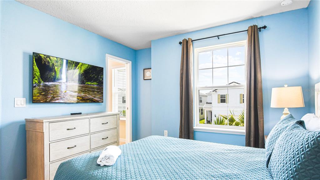 7219 Oakmoss Loop Davenport, FL 33837 - Photo 45 of 54 a bedroom with a bed and a dresser