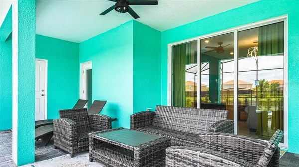 a backyard of a house with barbeque oven table and chairs