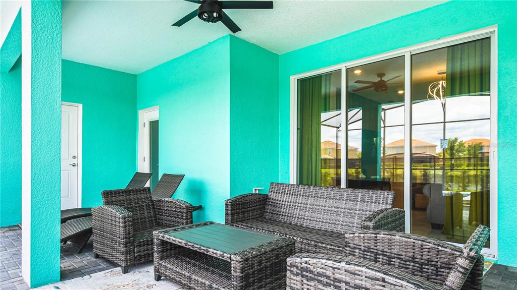 7219 Oakmoss Loop Davenport, FL 33837 - Photo 48 of 54 a outdoor living space with furniture and a garden