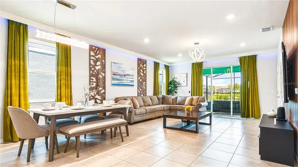 a living room with furniture and large windows