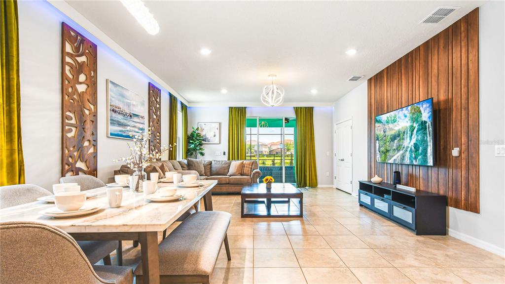 7219 Oakmoss Loop Davenport, FL 33837 - Photo 10 of 54 a living room with furniture and large windows