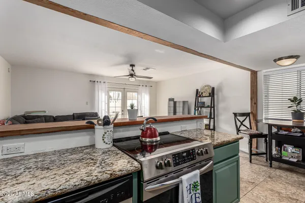 a kitchen with stove and cabinets