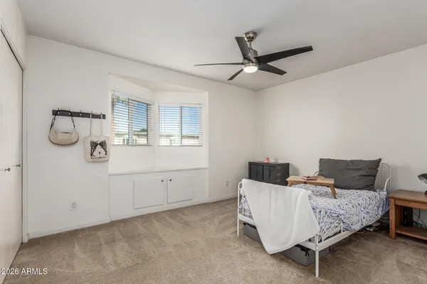 a living room with furniture and a ceiling fan
