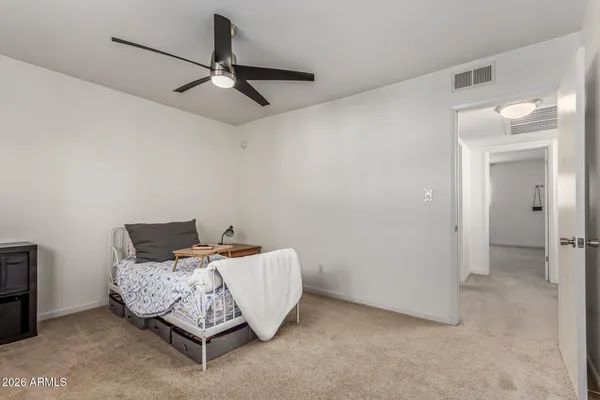 a bedroom with a bed and ceiling fan