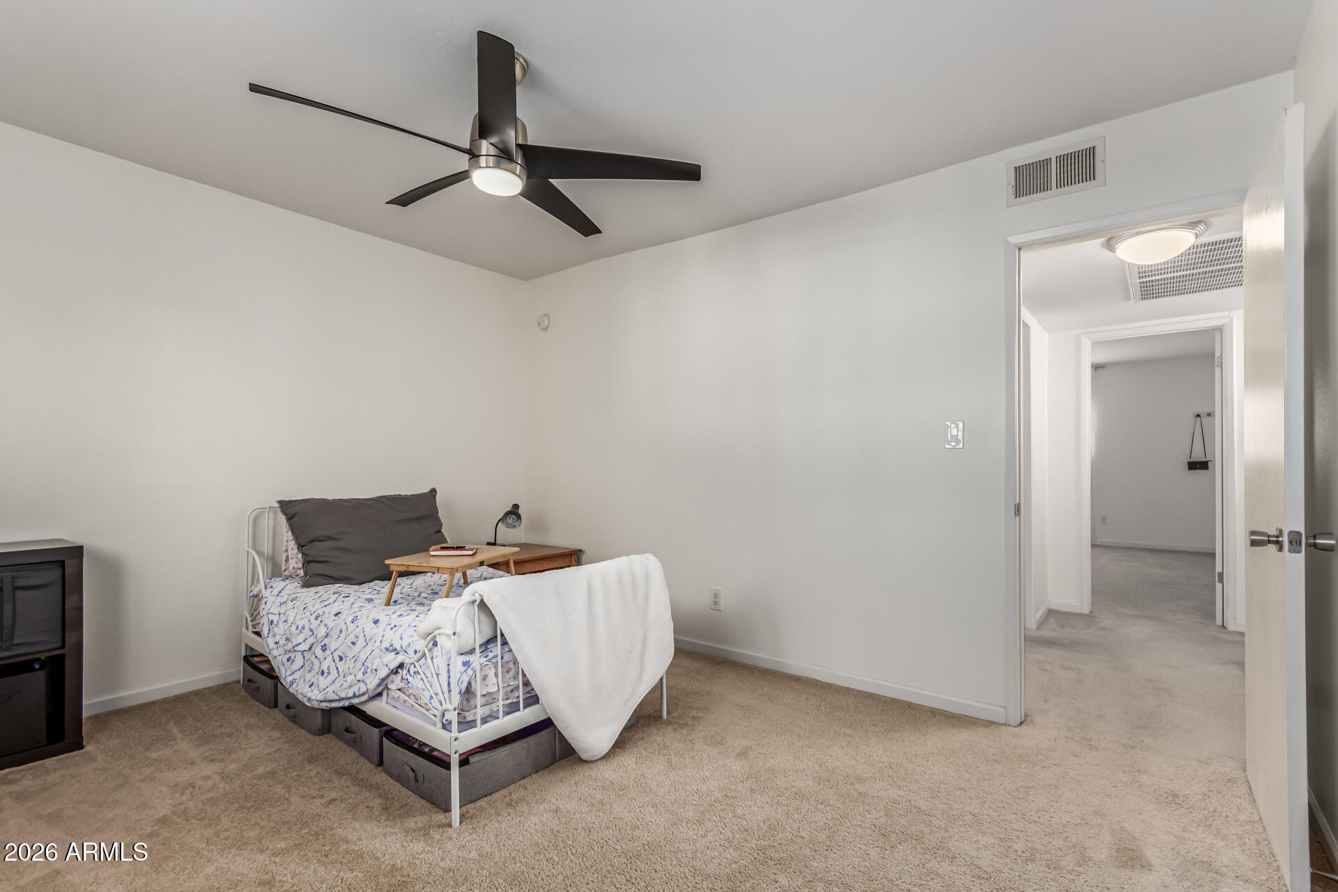 6040 North 15th Street, Unit 27 Phoenix, AZ 85014 - Photo 15 of 28 a bedroom with a bed and ceiling fan