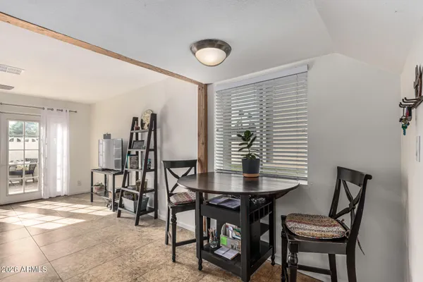 a view of a dining room with furniture and a window