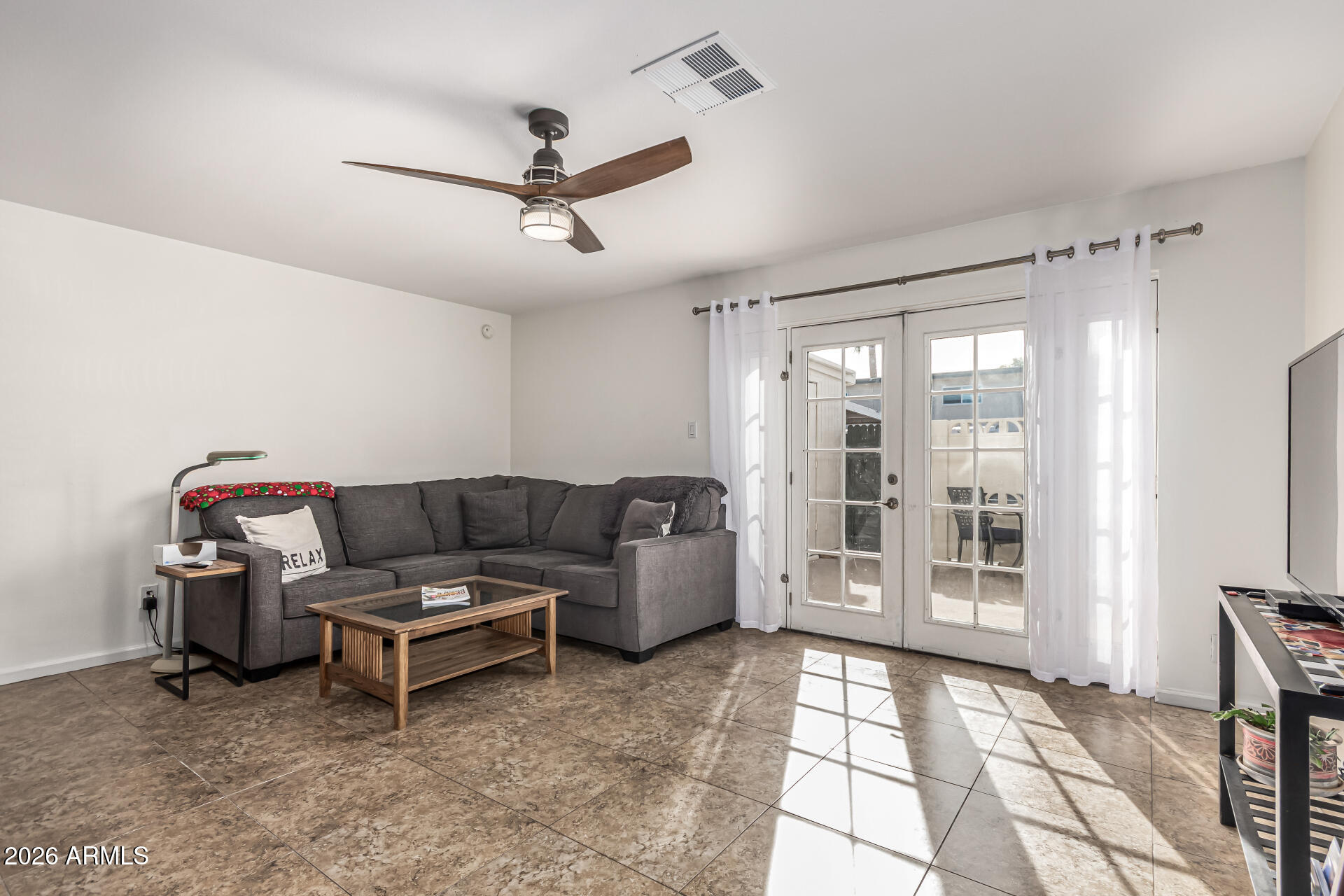 6040 North 15th Street, Unit 27 Phoenix, AZ 85014 - Photo 6 of 28 a living room with furniture and a floor to ceiling window