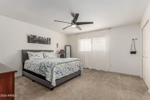 a spacious bedroom with a bed and window