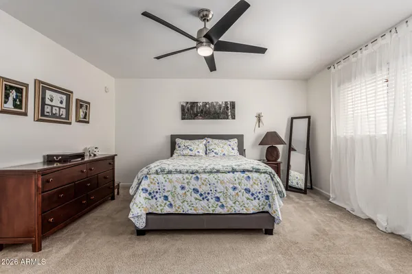 a bedroom with a bed and a tv