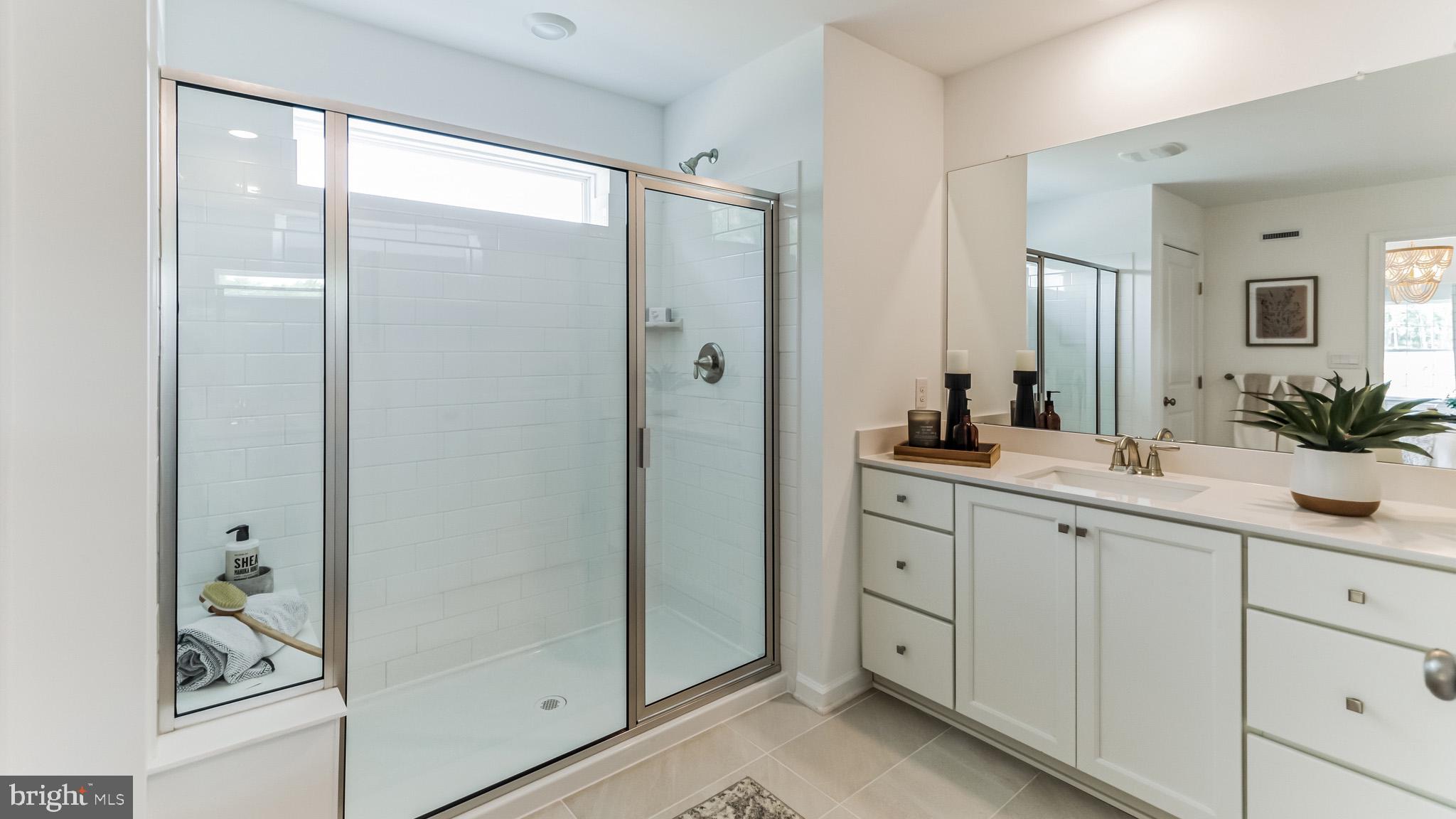 453 Clems Run Mullica Hill, NJ 08062 - Photo 28 of 35 a spacious bathroom with a shower sink and mirror