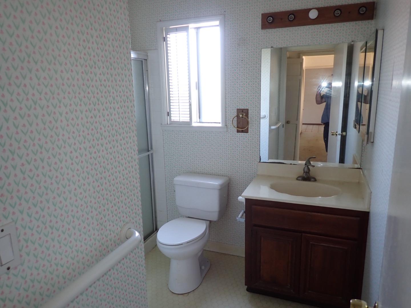 1955 Redwood Road Hercules, CA 94547 - Photo 16 of 23 a bathroom with a toilet a sink and mirror