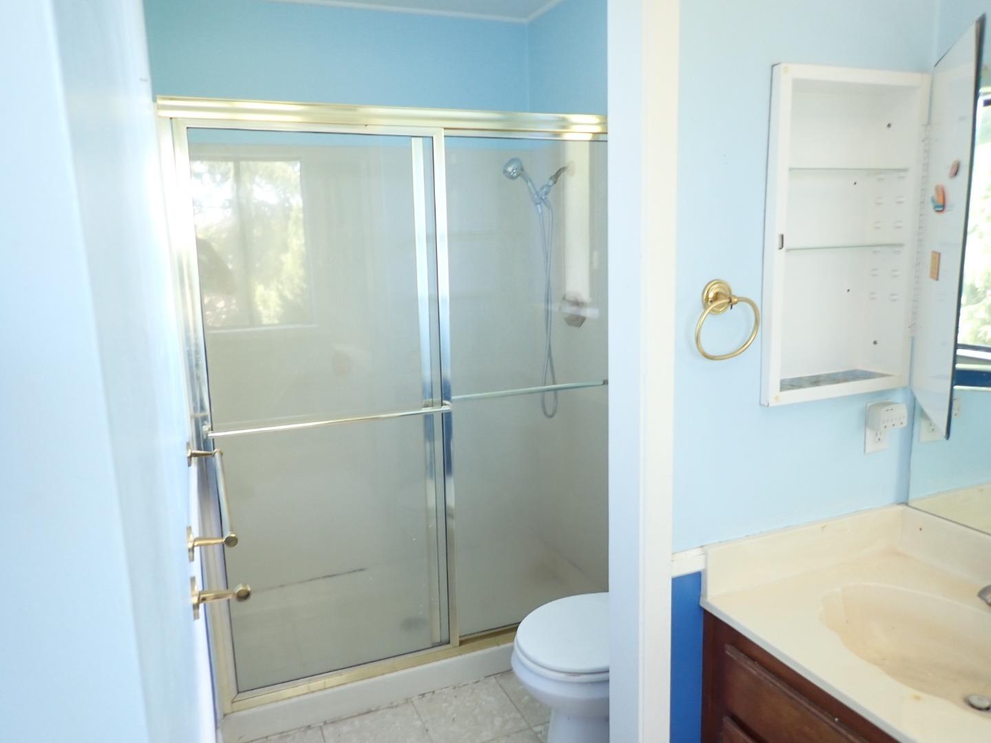1955 Redwood Road Hercules, CA 94547 - Photo 18 of 23 a bathroom with a shower toilet and sink