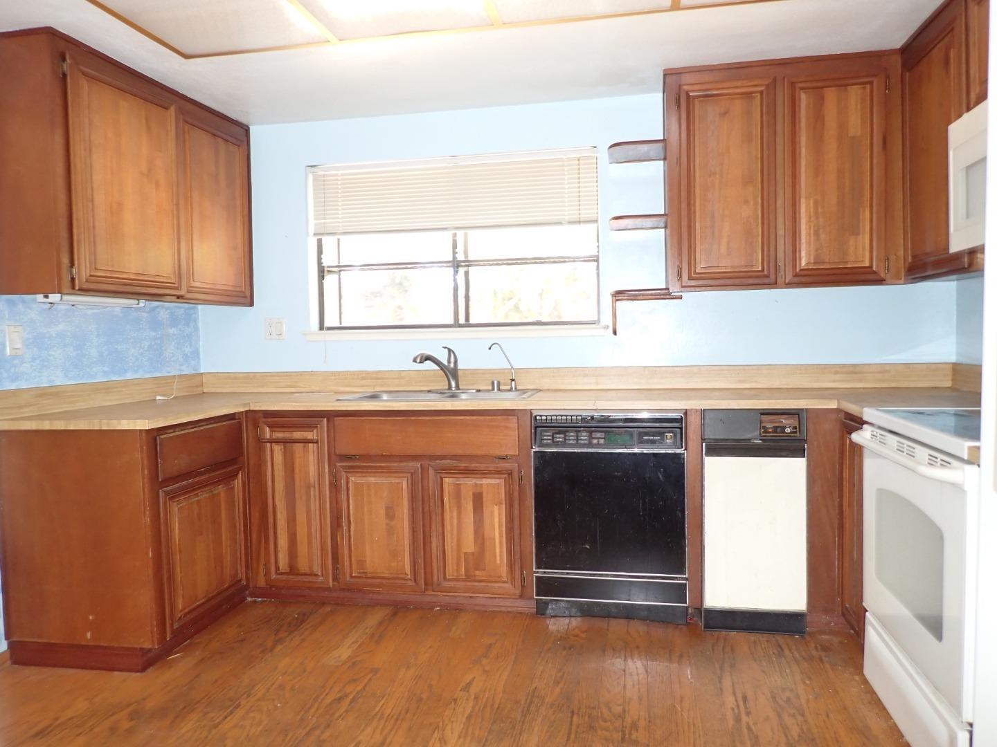 1955 Redwood Road Hercules, CA 94547 - Photo 7 of 23 a kitchen with stainless steel appliances granite countertop a stove a sink and a microwave