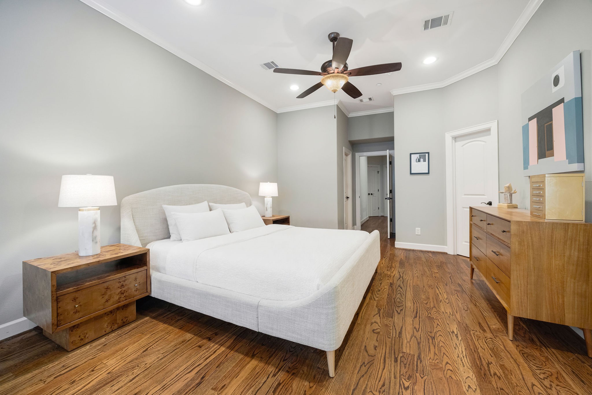 2415 Commonwealth Street Houston, TX 77006 - Photo 16 of 26 Elegant proportions, soaring ceilings, and rich hardwood floors define the spacious primary bedroom, creating a sophisticated and inviting owner's retreat.
