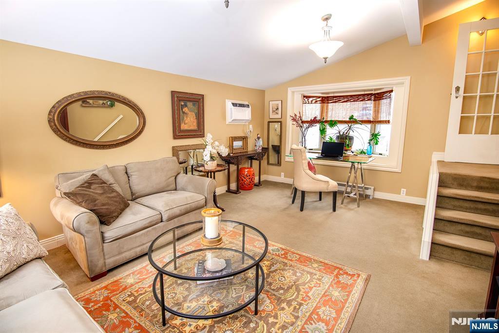 25 Maple Avenue Demarest, NJ 07627 - Photo 11 of 29 a living room with furniture a couch and two windows