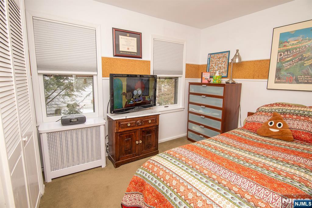 25 Maple Avenue Demarest, NJ 07627 - Photo 20 of 29 a bedroom with a bed and a flat screen tv