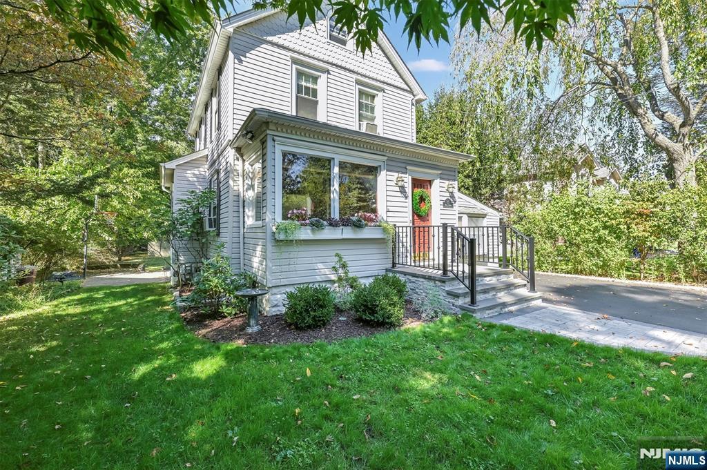 25 Maple Avenue Demarest, NJ 07627 - Photo 2 of 29 a front view of a house with a yard and porch