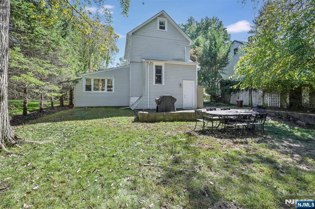 25 Maple Avenue Demarest, NJ 07627 - Photo 26 of 29 a backyard of a house with yard and outdoor seating