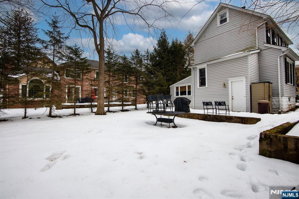 25 Maple Avenue Demarest, NJ 07627 - Photo 28 of 29 a view of a patio with a table and chairs under a large tree
