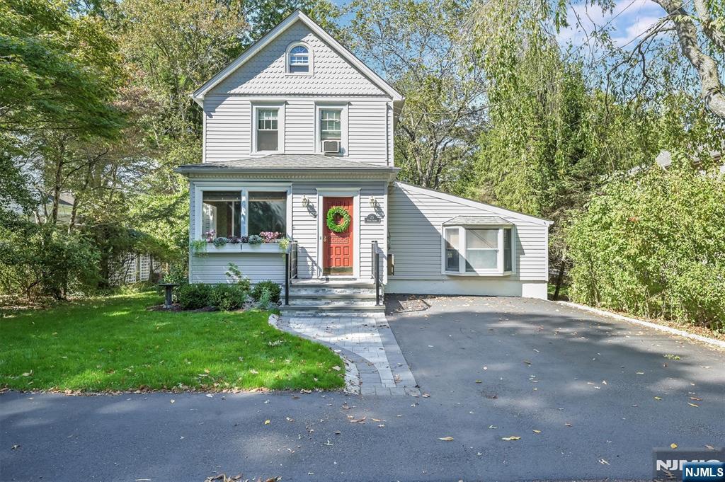 25 Maple Avenue Demarest, NJ 07627 - Photo 3 of 29 a front view of a house with a yard and garage