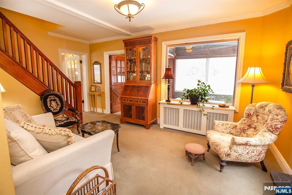 25 Maple Avenue Demarest, NJ 07627 - Photo 8 of 29 a living room with furniture a fireplace and a table