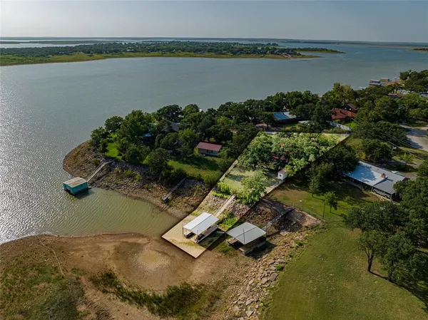 an aerial view of a house with a lake view