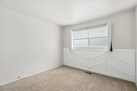 a view of an empty room with cabinet