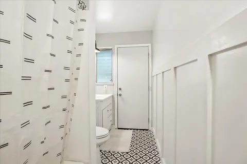 a bathroom with a shower and a toilet