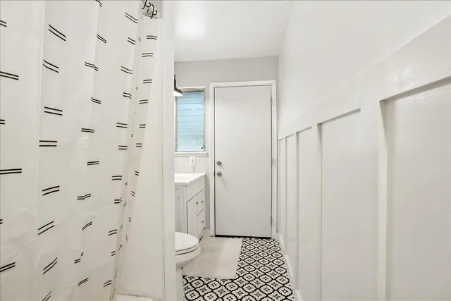 a bathroom with a shower and a toilet