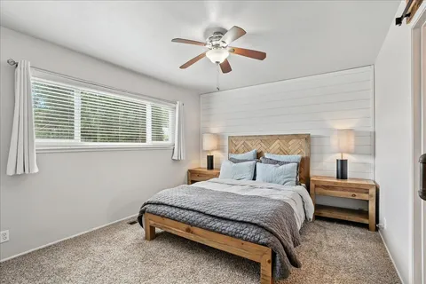 a bedroom with a bed and a chandelier