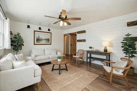 a living room with furniture and a potted plant