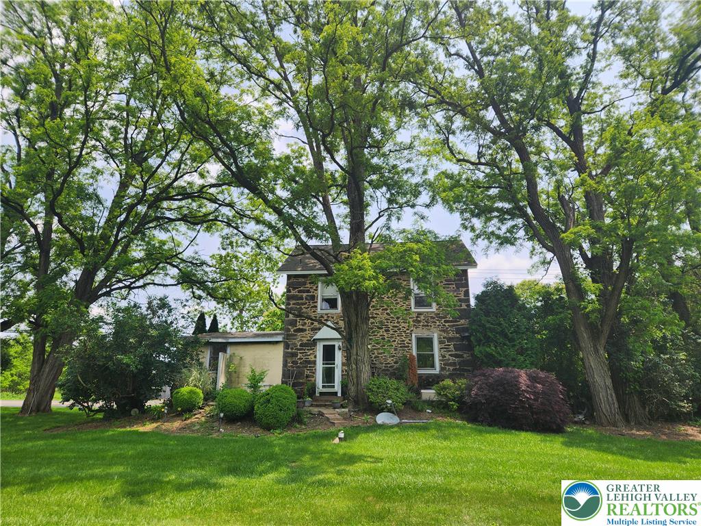 front view of a house with a tree