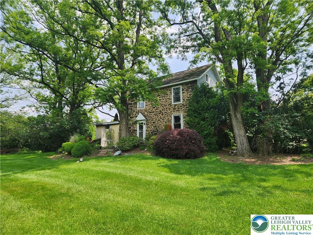 717 Point Phillips Road Bath, PA 18014 - Photo 3 of 34 a view of a house with yard and a garden