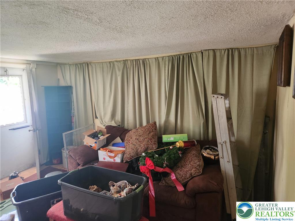 717 Point Phillips Road Bath, PA 18014 - Photo 33 of 34 a living room with furniture and a fireplace