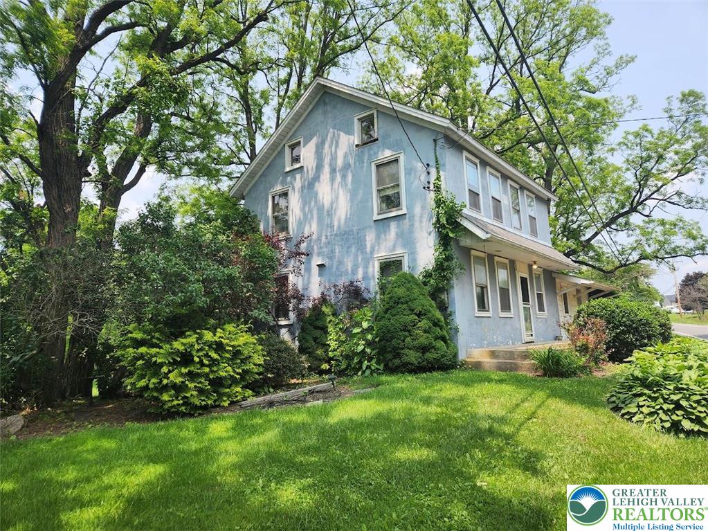717 Point Phillips Road Bath, PA 18014 - Photo 7 of 34 a front view of a house with a yard and trees