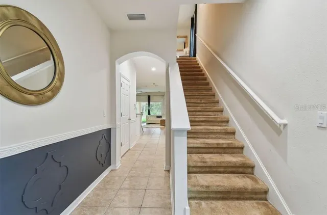 a view of a hallway with entryway wooden floor and front door