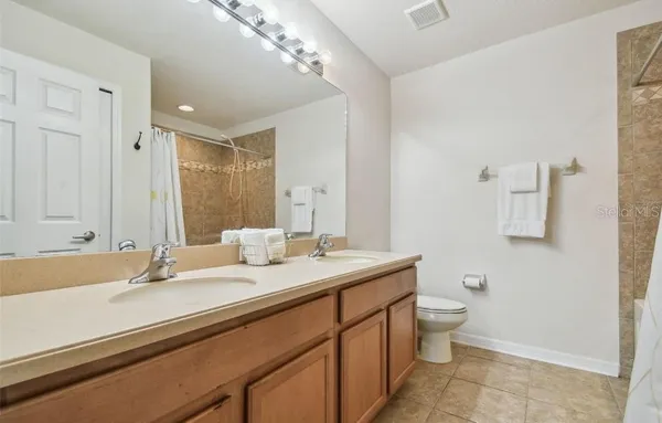 a bathroom with a sink double vanity and a mirror