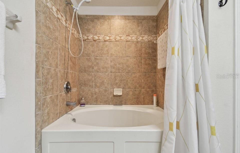 11523 84th St Circle East, Unit 106 Parrish, FL 34219 - Photo 16 of 27 a bathroom with a shower and a bathtub