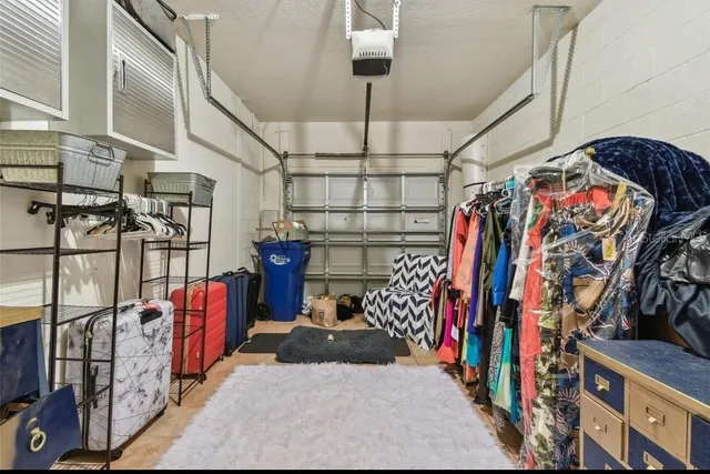 a view of walk in closet with clothes