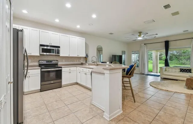 a kitchen with a sink cabinets and stainless steel appliances