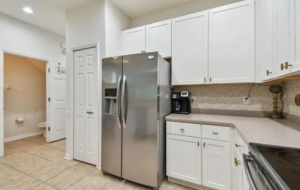 a kitchen with a refrigerator and cabinets